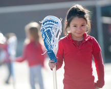 donations_main girl holding lacrosse stick